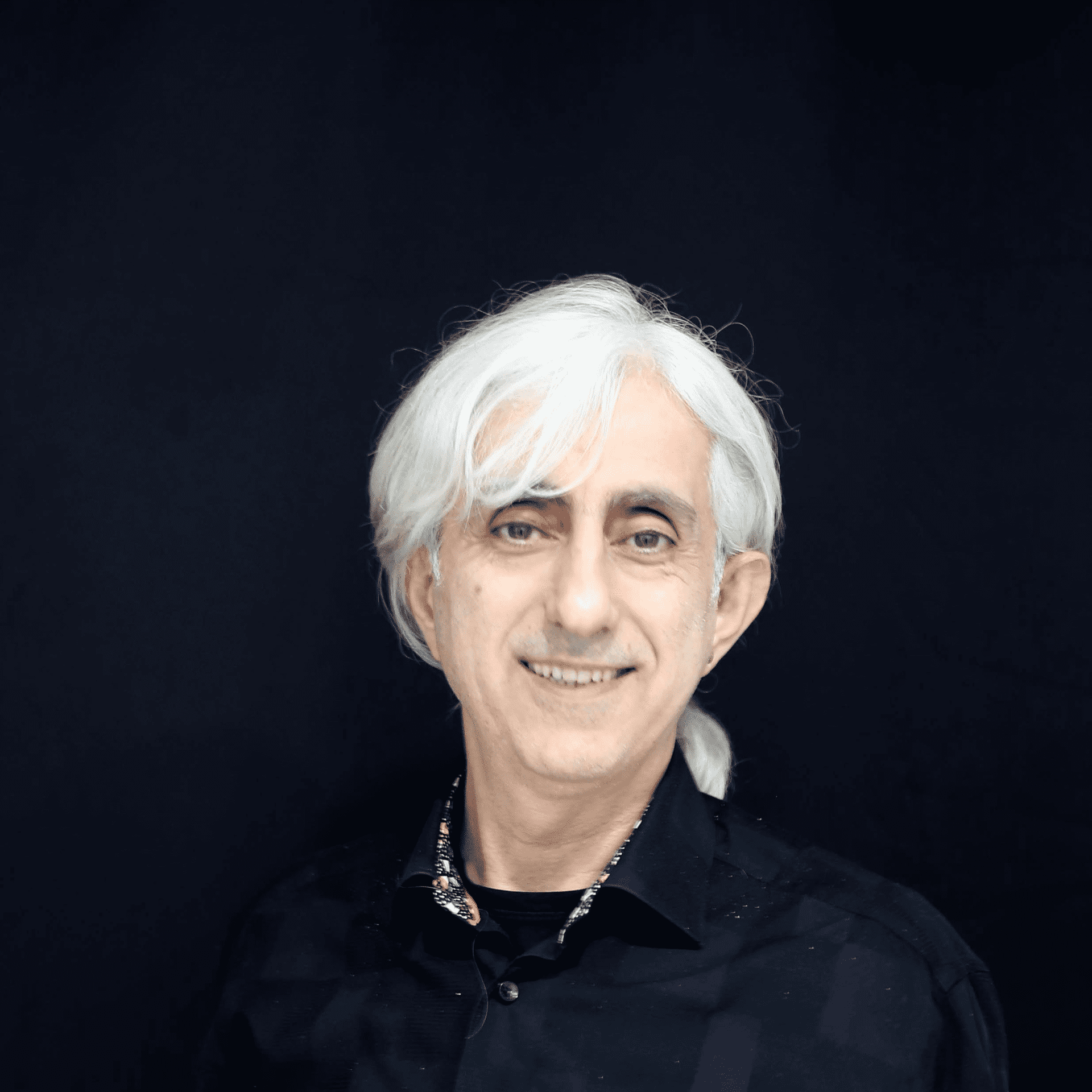 Portrait of John Kaygisiz, a professional stylist at Toka Salon, showcasing their expertise and style.