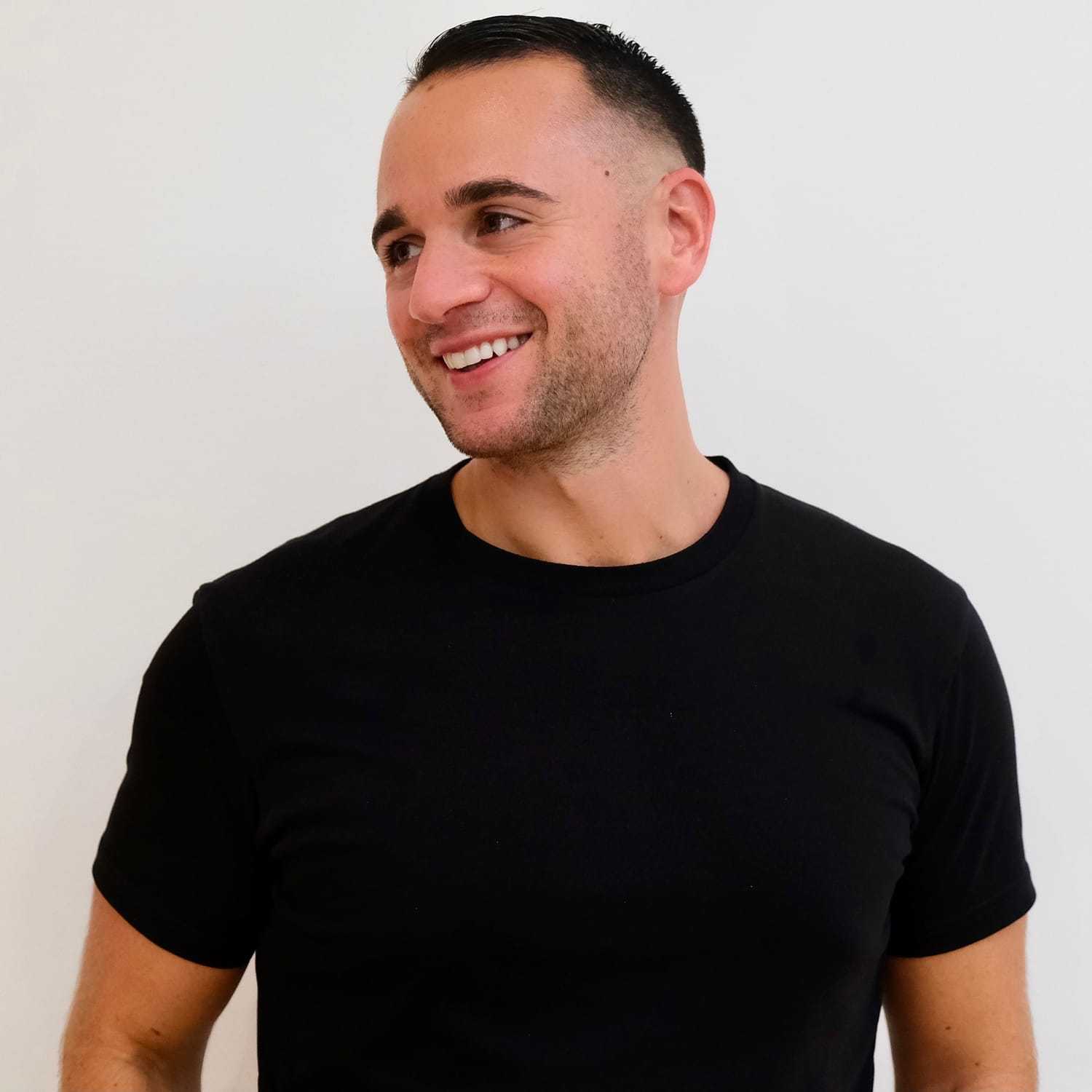Portrait of Connor John, a professional stylist at Toka Salon, showcasing their expertise and style.