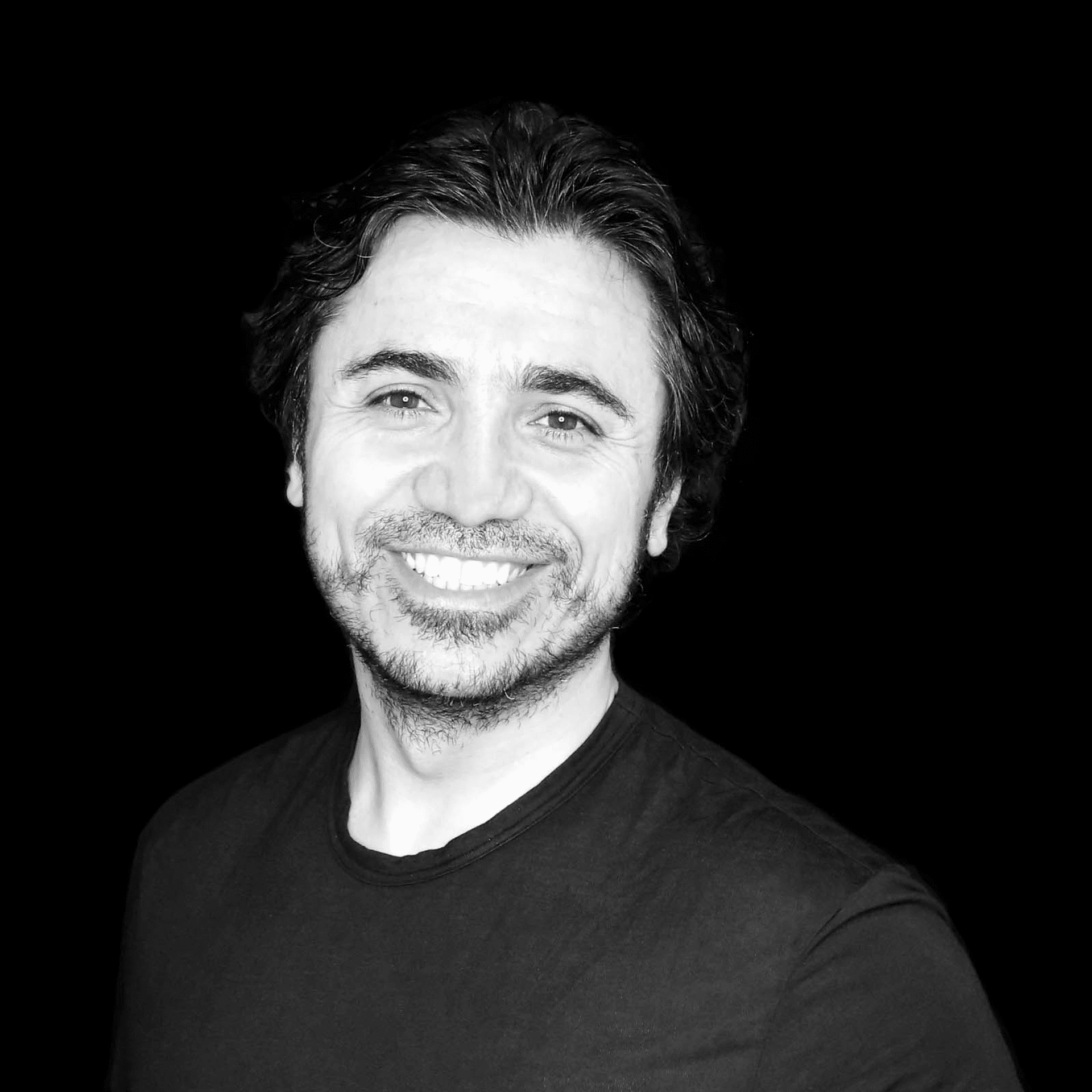 Portrait of Erdogan Celik, a professional stylist at Toka Salon, showcasing their expertise and style.
